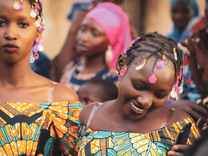 Girls in colorful dress smiling together