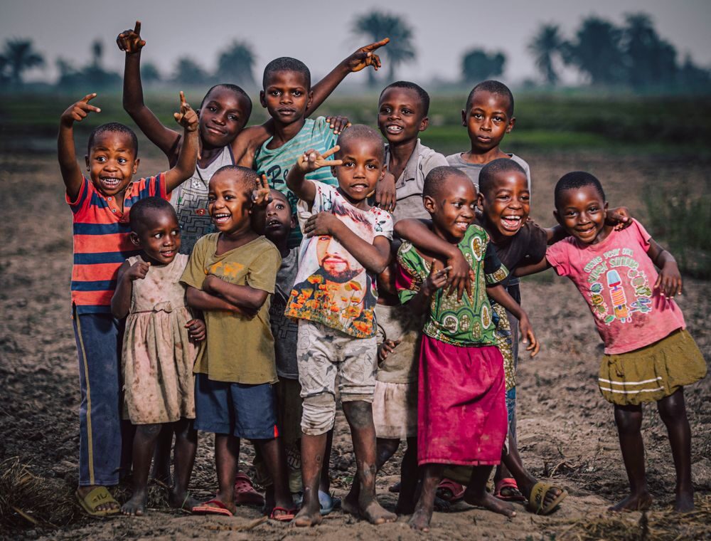 A group of joyful children with arms raised